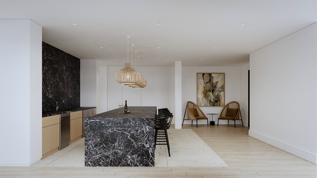 a kitchen with a marble island and a dining room with a table and chairs