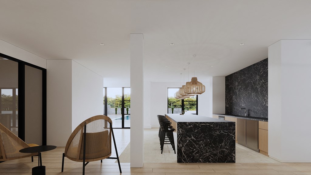 a kitchen and dining room with a marble counter top and a table with chairs