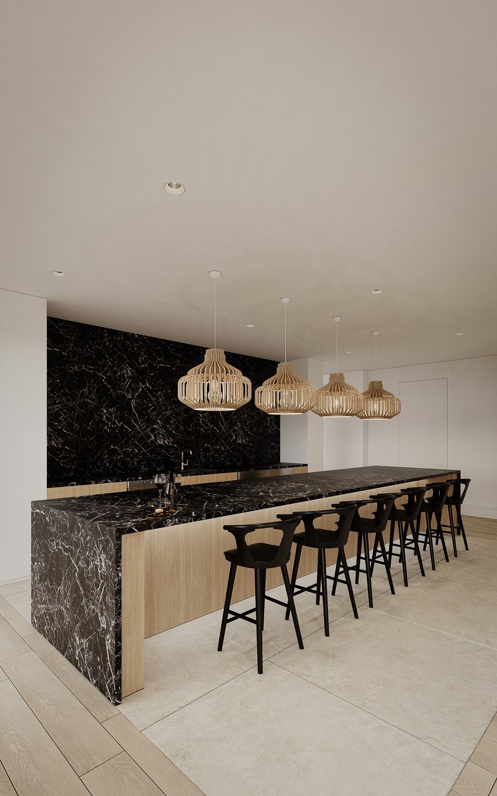 a large kitchen with a long bar and black marble