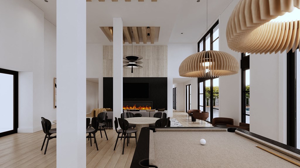 a large room with a pool table and chairs and a fireplace