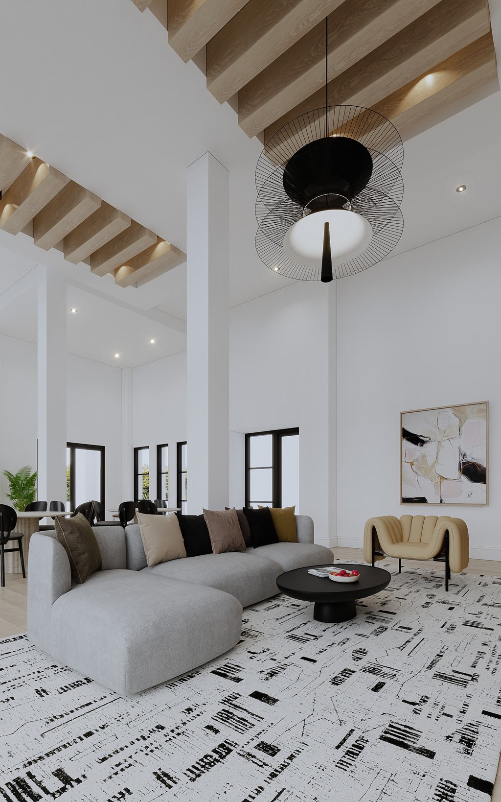 a living room with a gray couch and a black and white rug