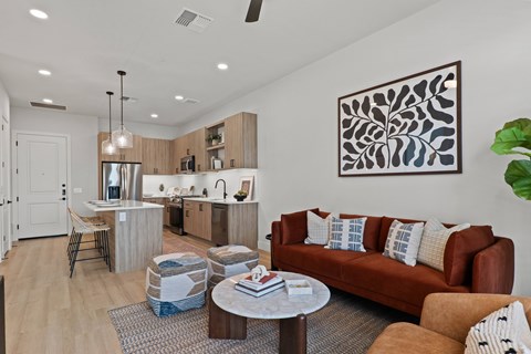 A modern living room with a brown couch and a coffee table.