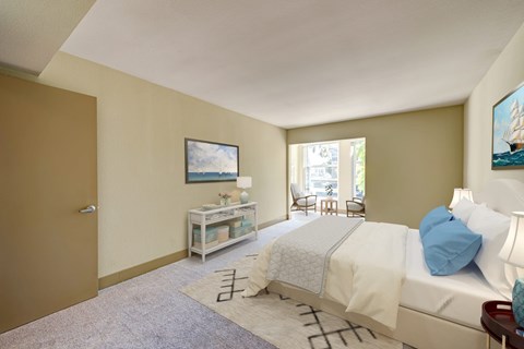 A bedroom with a bed, nightstand, and chair.