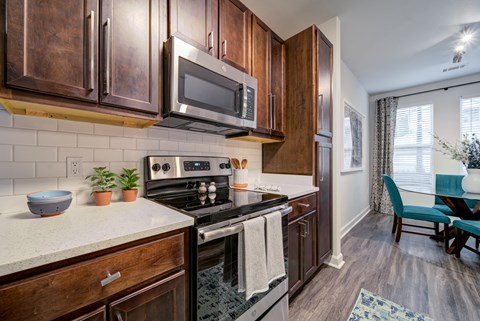 A kitchen with wooden cabinets and a black stove top oven.