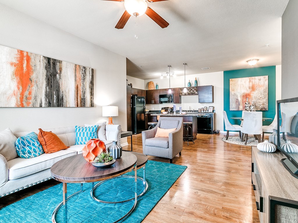 a living room with a white couch and a blue rug