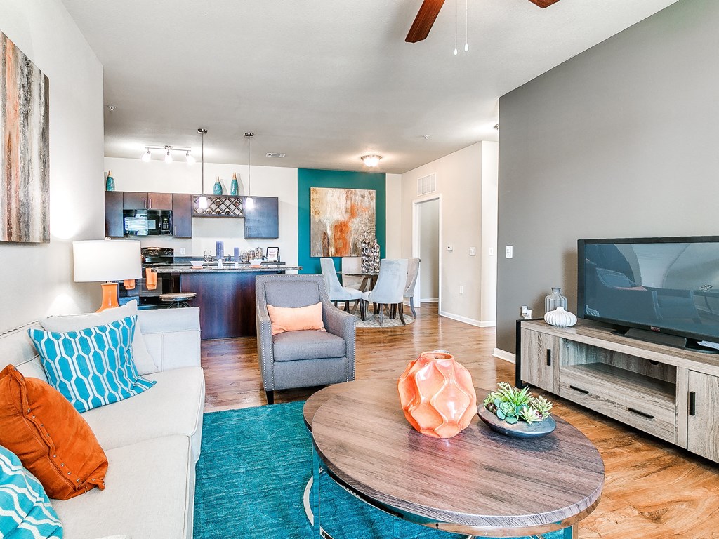 a living room with a couch and a chair in front of a tv
