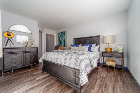 a bedroom with a large bed and a mirror