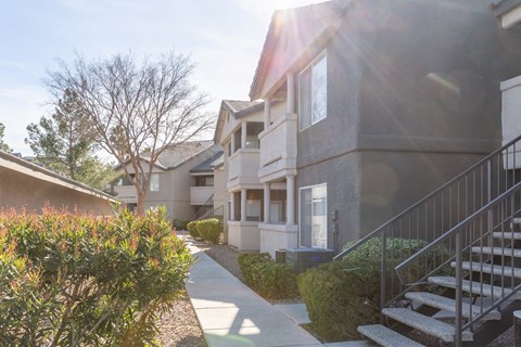 a row of houses with stairs and a sidewalk