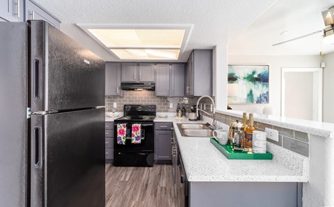 a kitchen with stainless steel appliances and granite counter tops