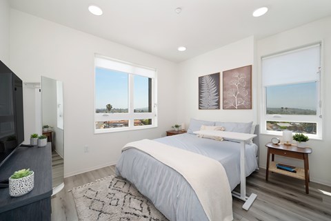 A bedroom with a large bed and a view of the ocean.