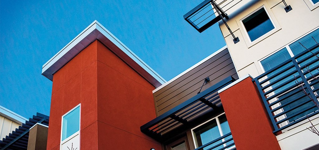 a red and white building with a blue sky in the background