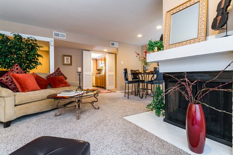 a living room with a fireplace and a couch and a table