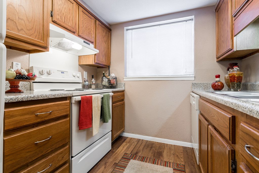 a kitchen with wood cabinets and white appliances