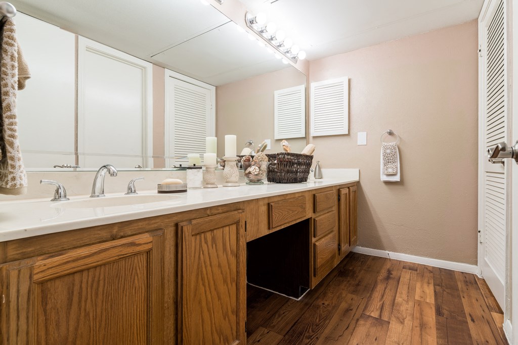 a bathroom with a large vanity with two sinks and a large mirror