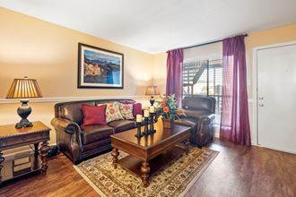a living room with a leather couch and coffee table