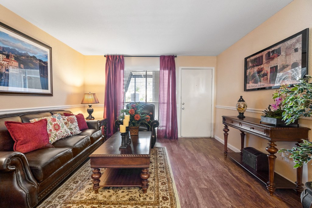 a living room with a leather couch and coffee table
