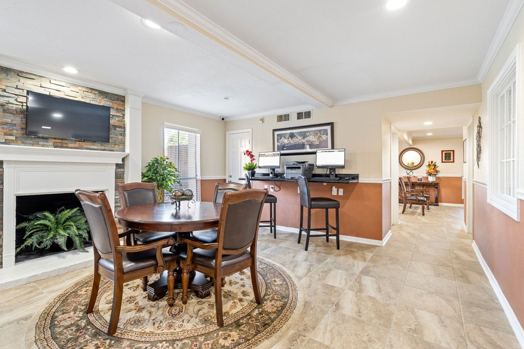 a dining area with a table and chairs and a fireplace