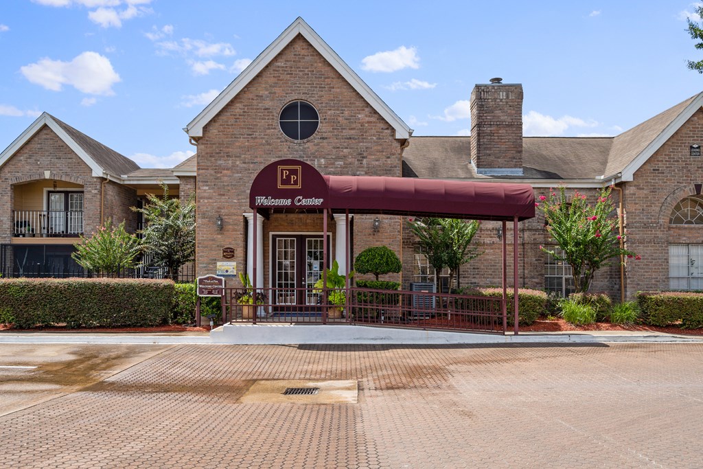 a brick building with a red awning in front of it