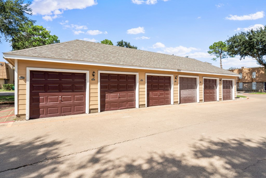 a row of garage doors in front of a house