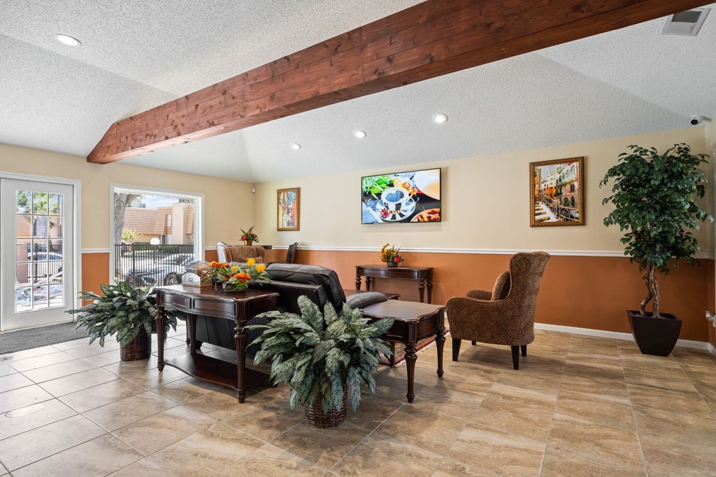 a resident clubhouse with a couch chairs and tables