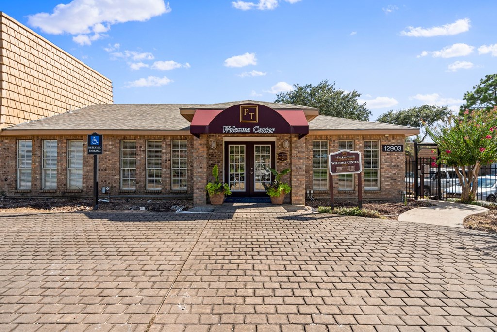 a brick building with a red and black awning
