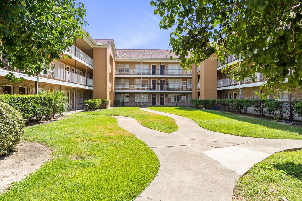 a large building with a grassy area in front of it