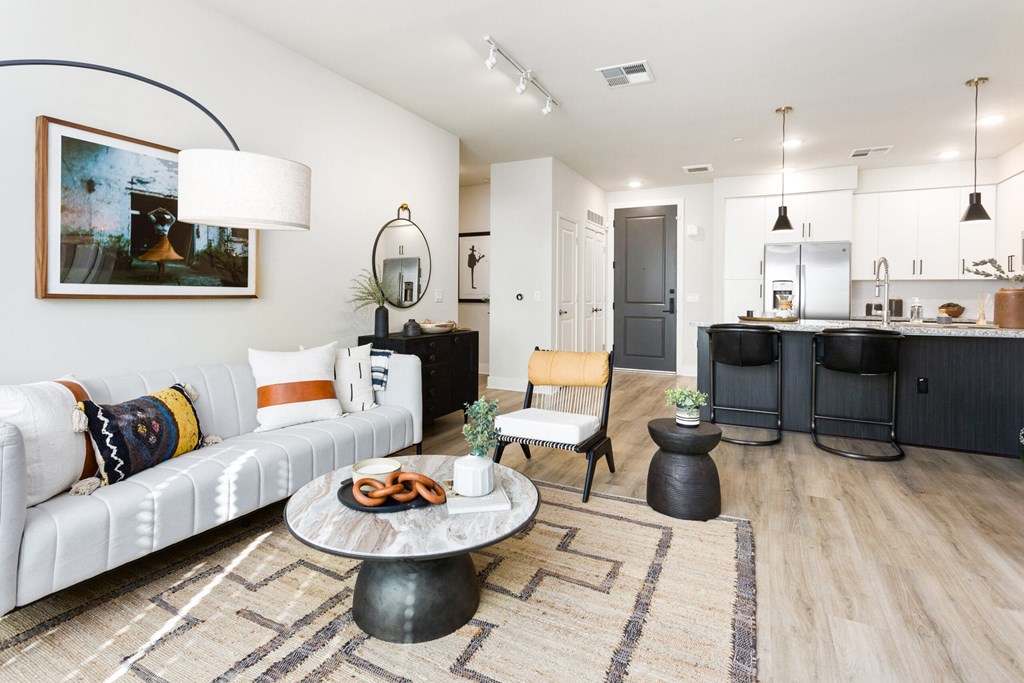 A modern living room with a white sofa and a coffee table.