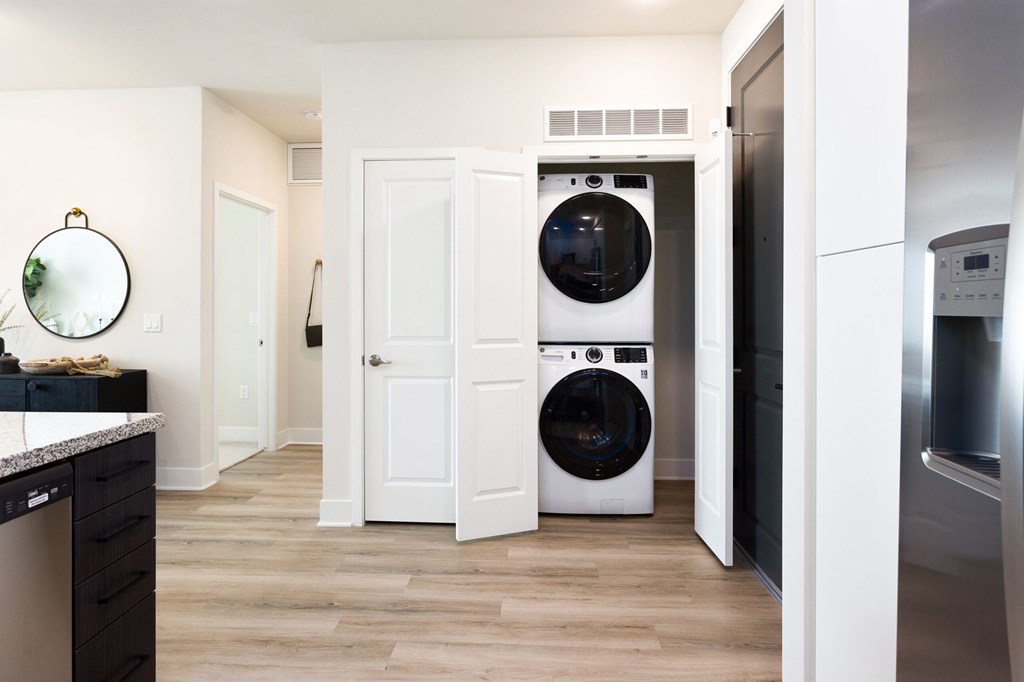 A laundry room with a washer and dryer built into the wall.