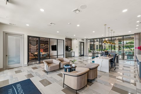 A spacious living room with a blue area rug and a large window.