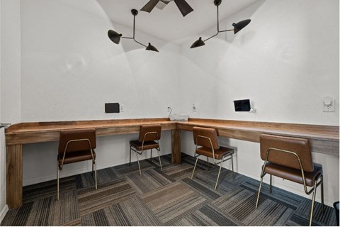 a long wooden table with chairs in a room