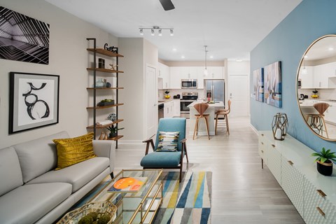 A modern living room with a grey sofa and a blue armchair.