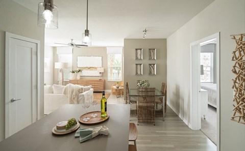A modern dining room with a table set for two.