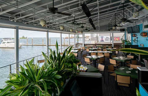 A restaurant with a view of the water and a boat.