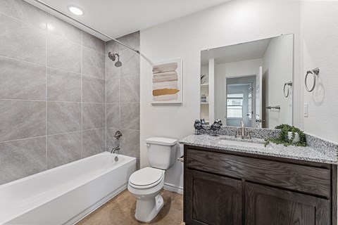 a bathroom with a sink toilet and a bath tub