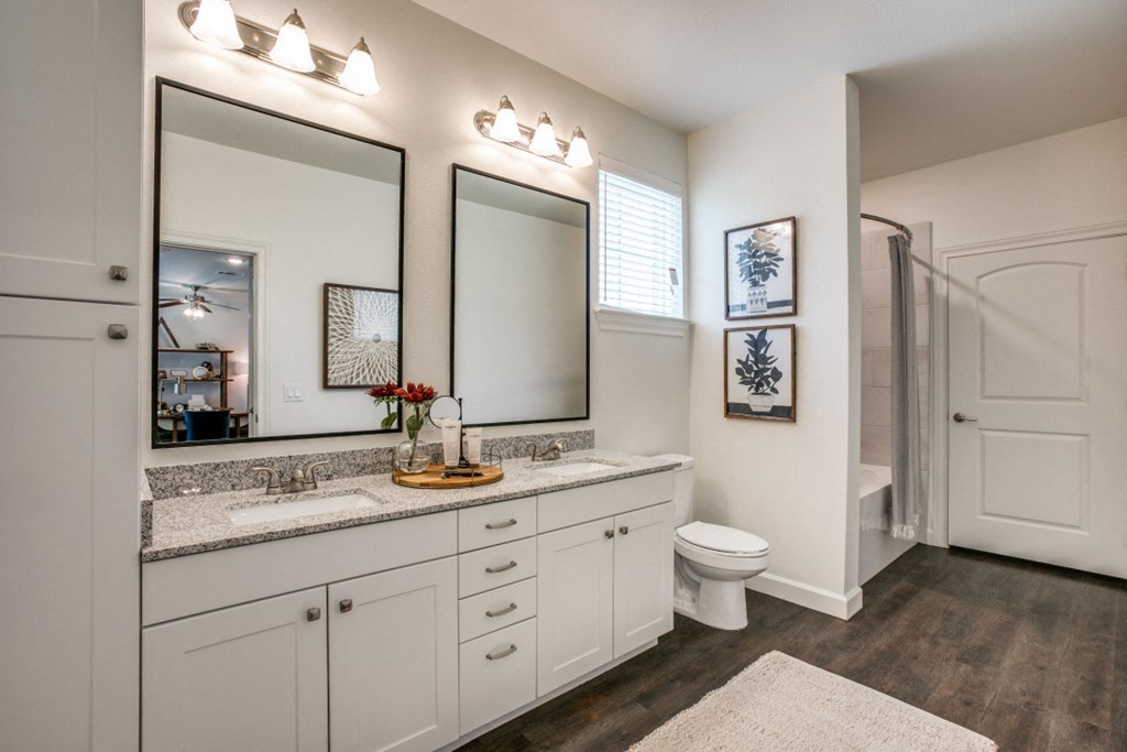 a bathroom with two mirrors and a toilet