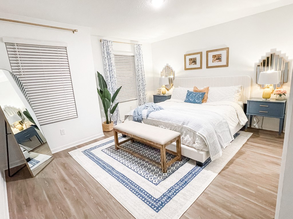 a bedroom with a bed and a rug