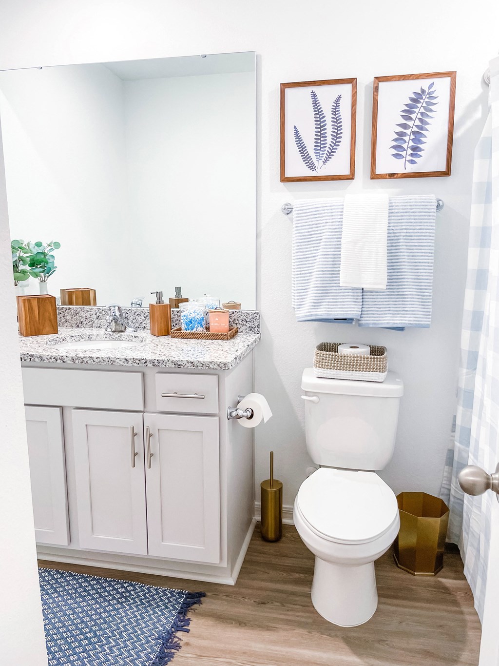 a small bathroom with a toilet and a sink and a shower curtain