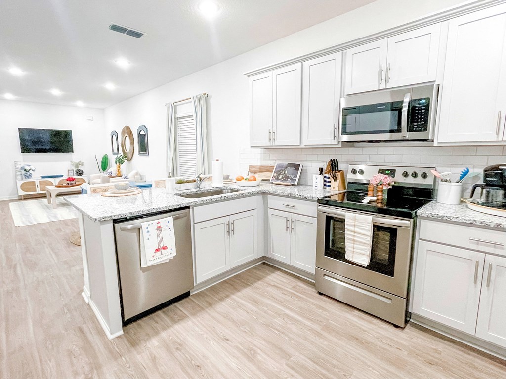 a kitchen with stainless steel appliances and white cabinets