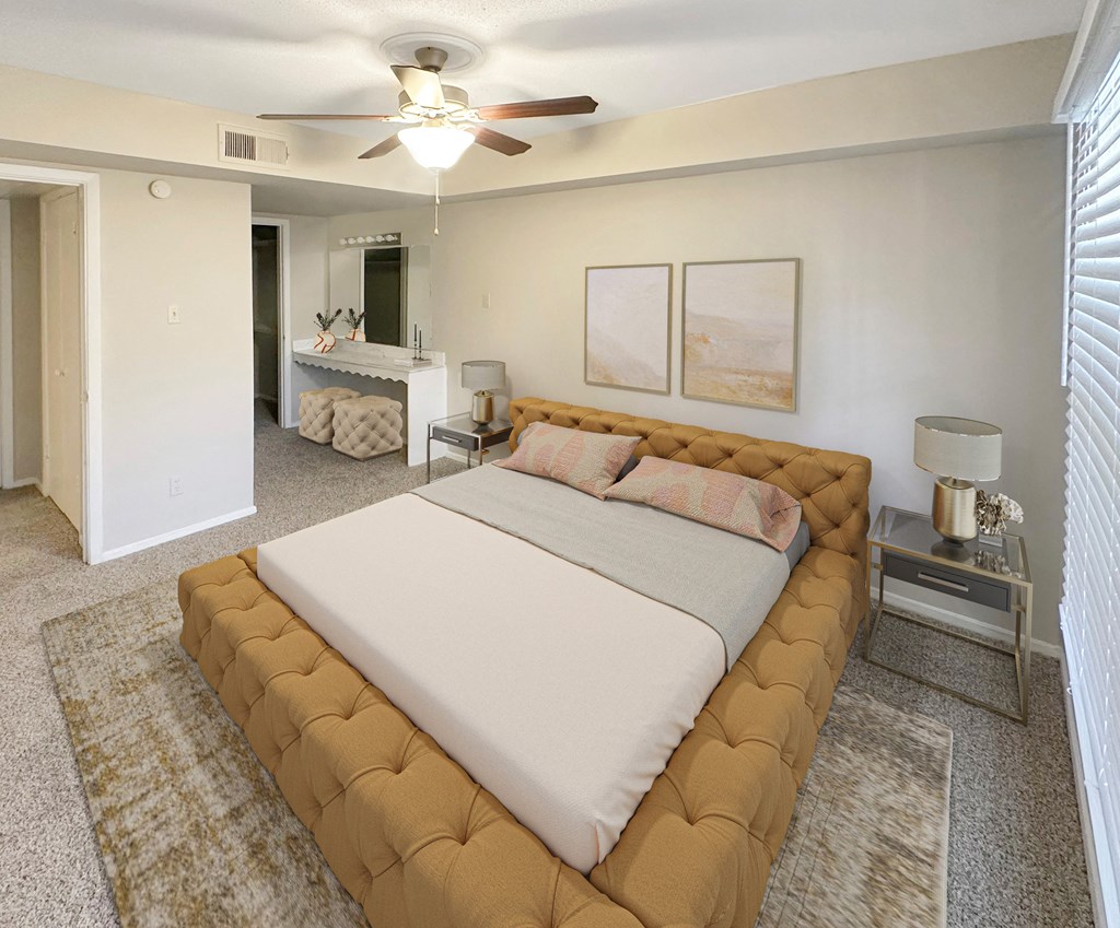 a bedroom with a bed and a ceiling fan