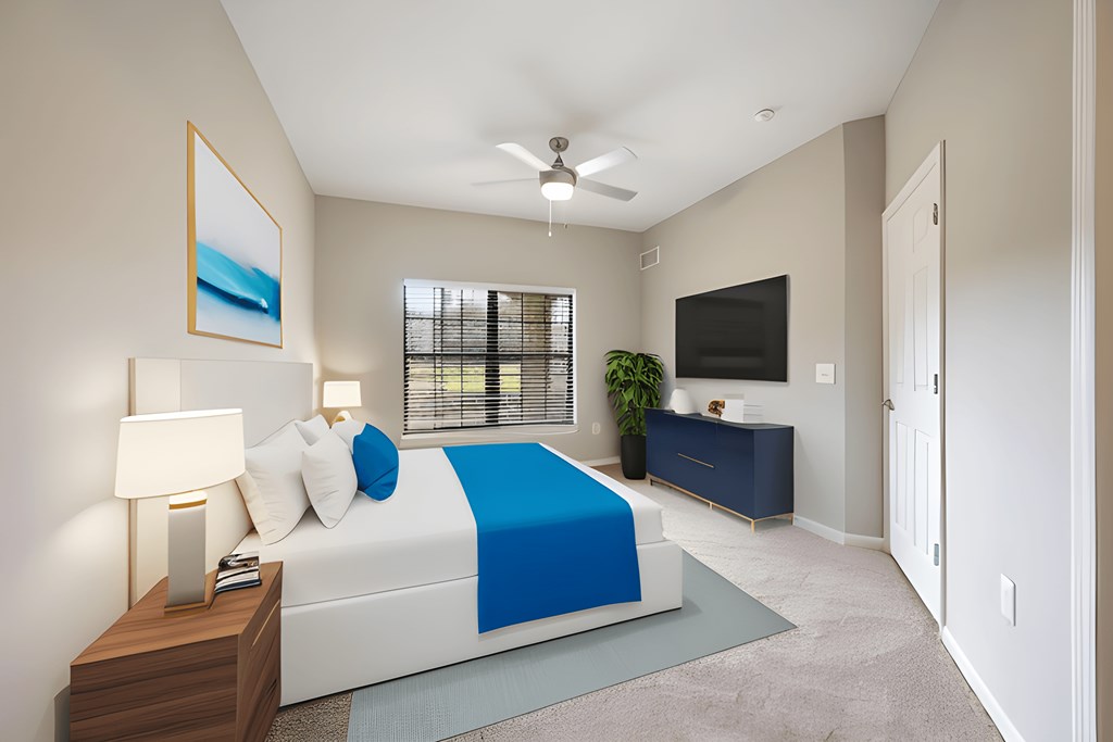 a bedroom with a white bed and a blue blanket