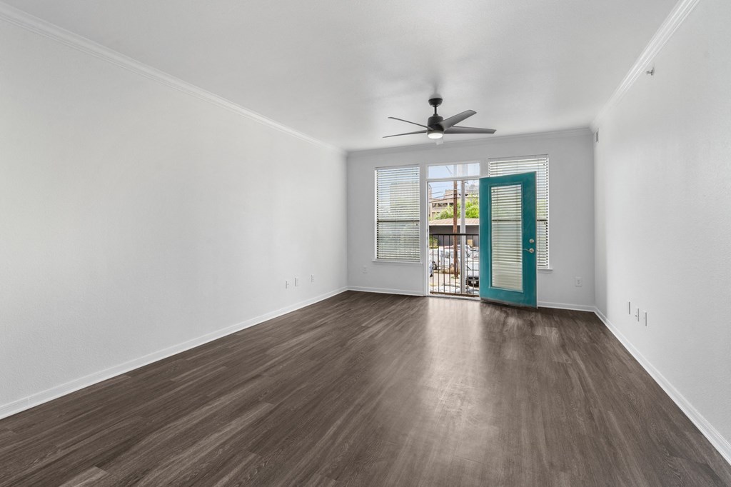 a living room with white walls and a blue door