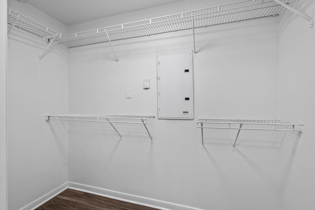 a room with white walls and white shelves