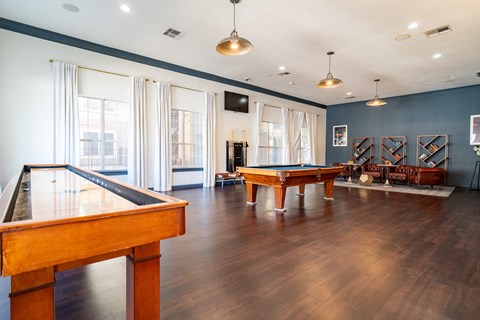 a game room with a pool table and ping pong