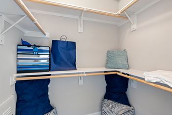 A small room with two bunk beds and a shelf.