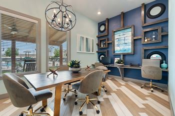 A conference room with a long table and chairs.