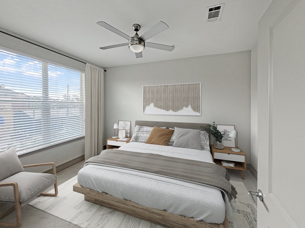 a bedroom with a large bed and a ceiling fan