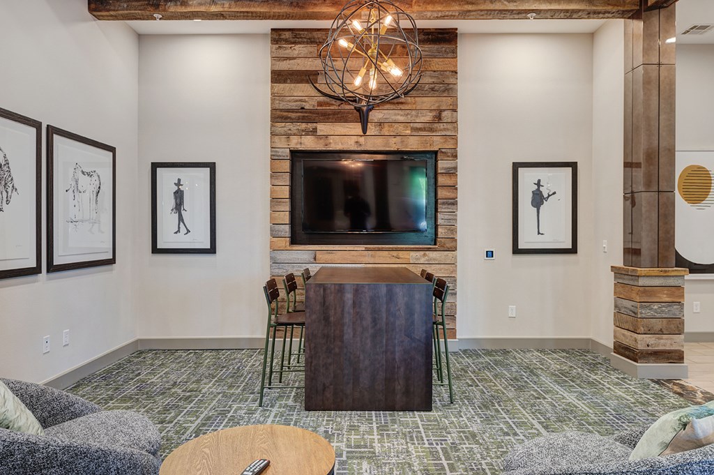 A living room with a wooden floor and a fireplace.