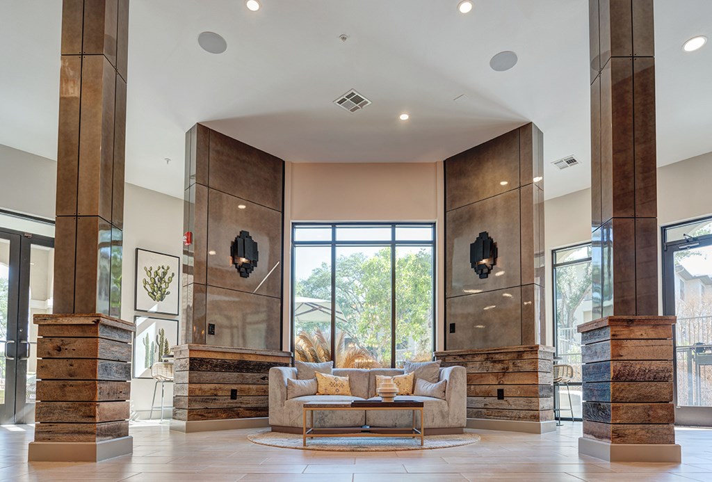 A large, modern living room with a glass door and a couch.