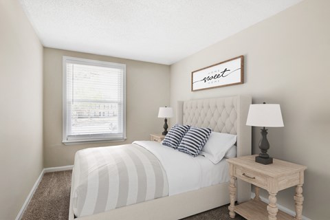 a bedroom with a large bed and a window