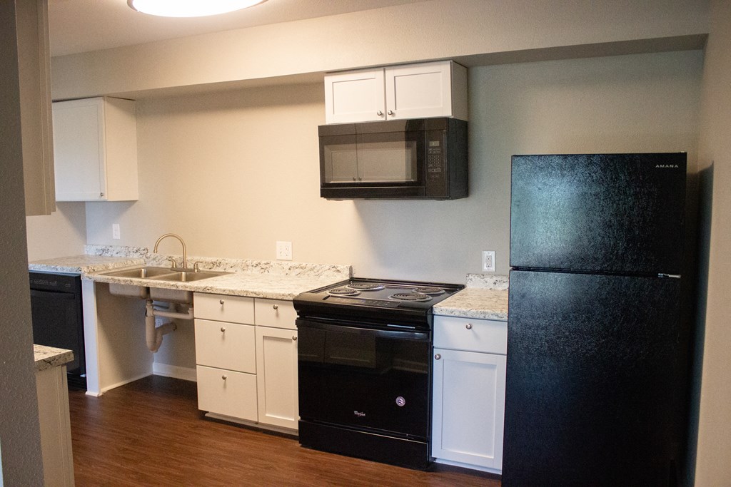 spacious kitchen view with nice appliances